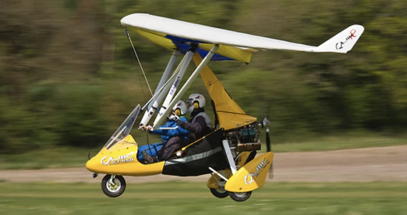 Flex-wing microlight plane coming in for landing on a field