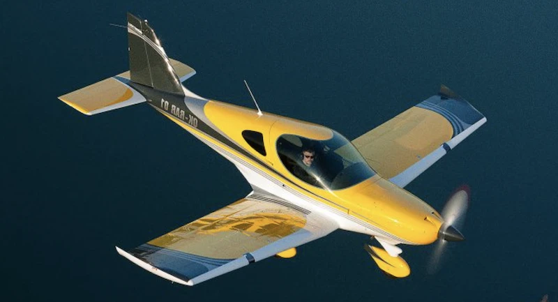 Low wing microlight cruising over the ocean