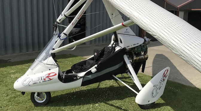 Modern white microlight aircraft with its wings collapsed